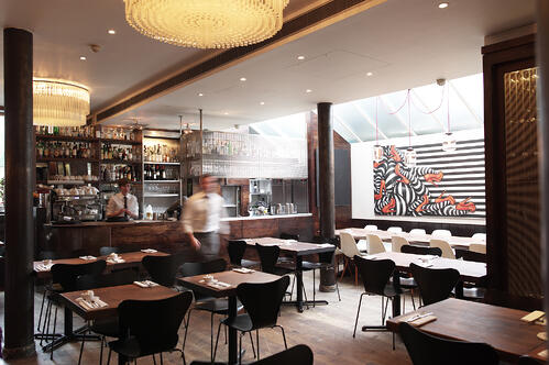 Turret Pendant Lights over a table at Jamie Oliver's Fifteen restaurant