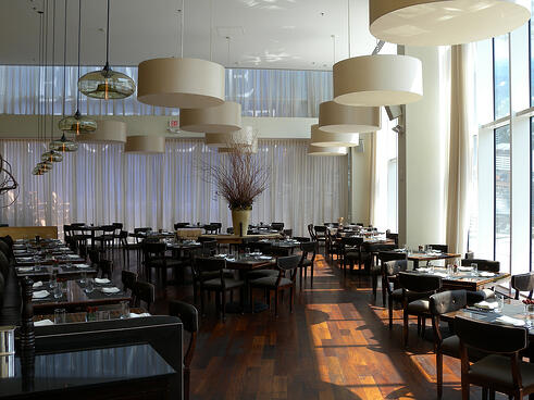 Niche Modern Aurora pendant lights above bar in restaurant