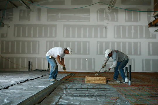 Workers cut re-bar before the concrete floor pouring