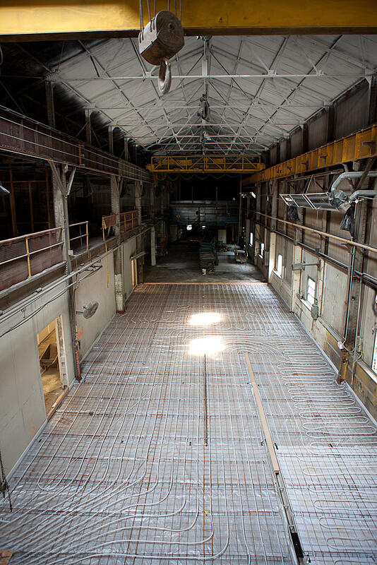 The hot shop floor covered in steel mesh and tubing for radiant heating