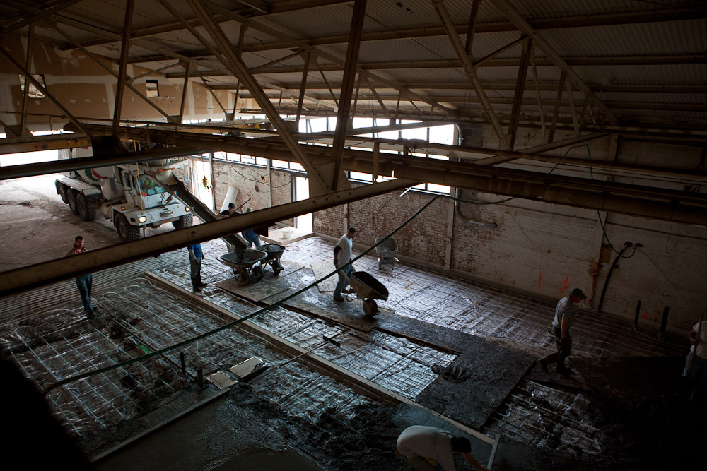 Workers quickly fill in the mold for the first half of the cold shop floor