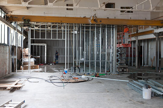 Workers frame up walls in the cold working space