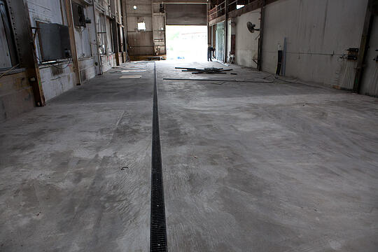 A view of the finished concrete floor in the future hot shop