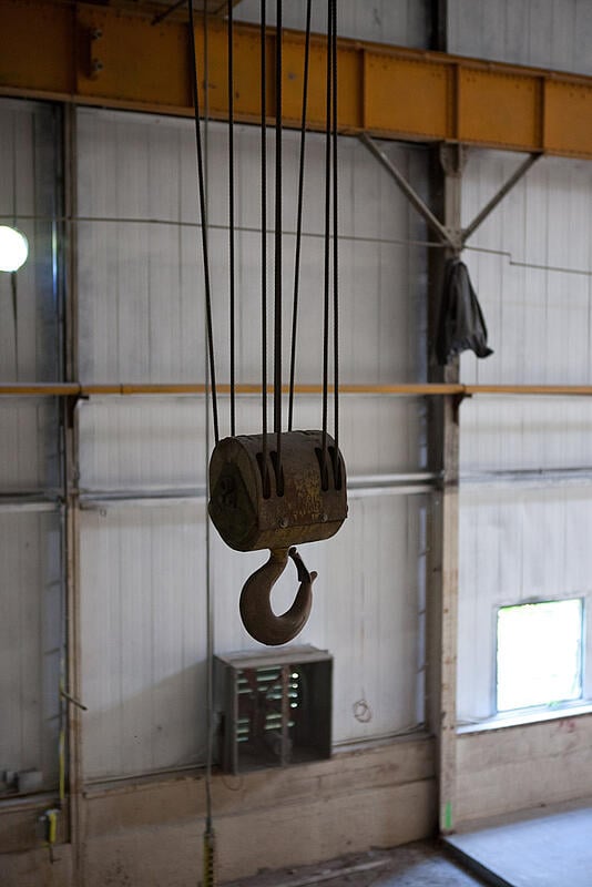 The crane hook hovering over the hot shop floor