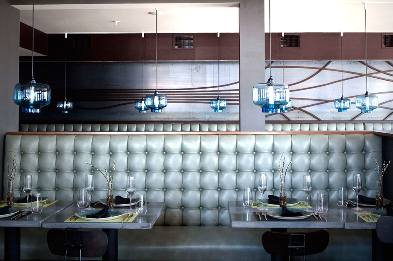 Oculo Pendants dangling above tables in the dining room