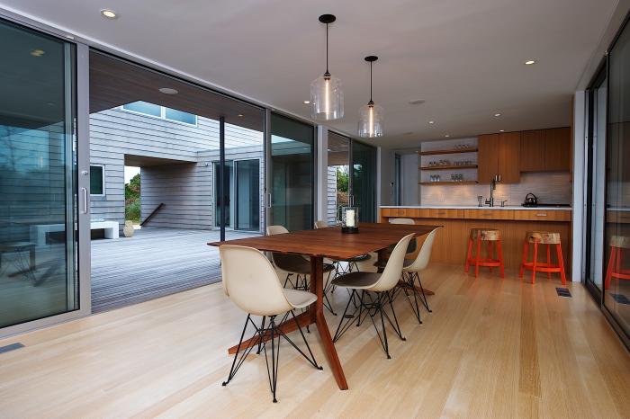 Bell Jar Pendant Lights Hanging over a Dining Room Table in Amagansett