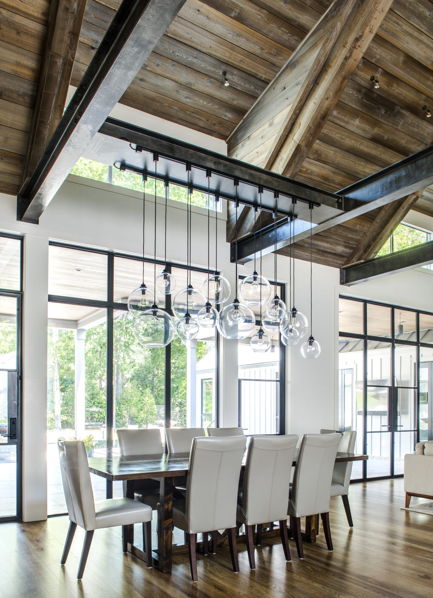 Harrison Design Modern Farmhouse Dining with Niche handmade glass lighting pendants in the color crystal, Terra, Solitaire, and Solitaire Petite