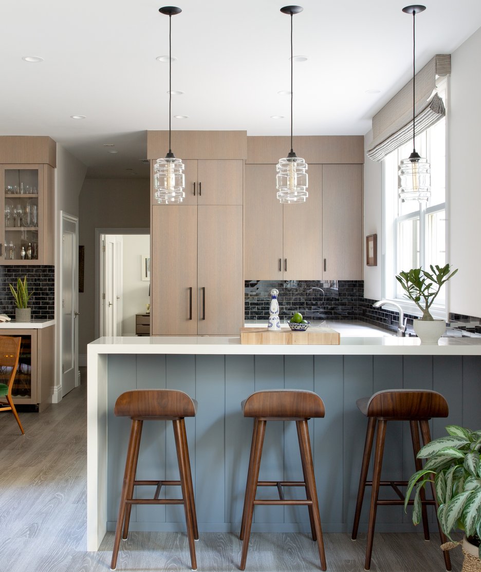 Three modern glass pendant lights over a kitchen island